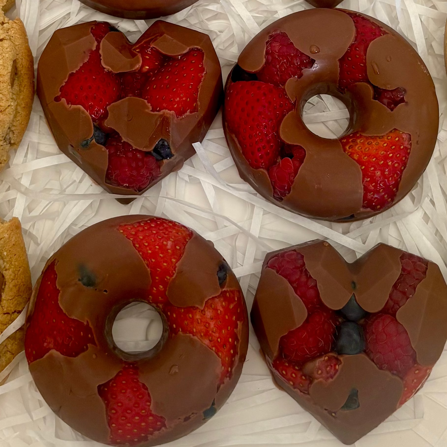 Chocolate-covered mixed berries and decorated chocolate shapes